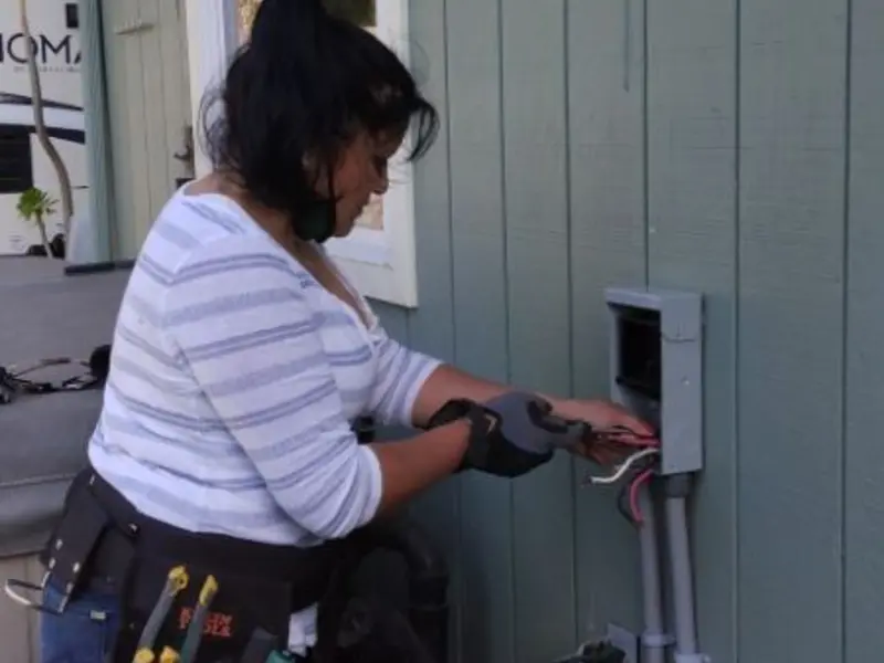 Licensed electrician wiring an exterior subpanel in Malverne