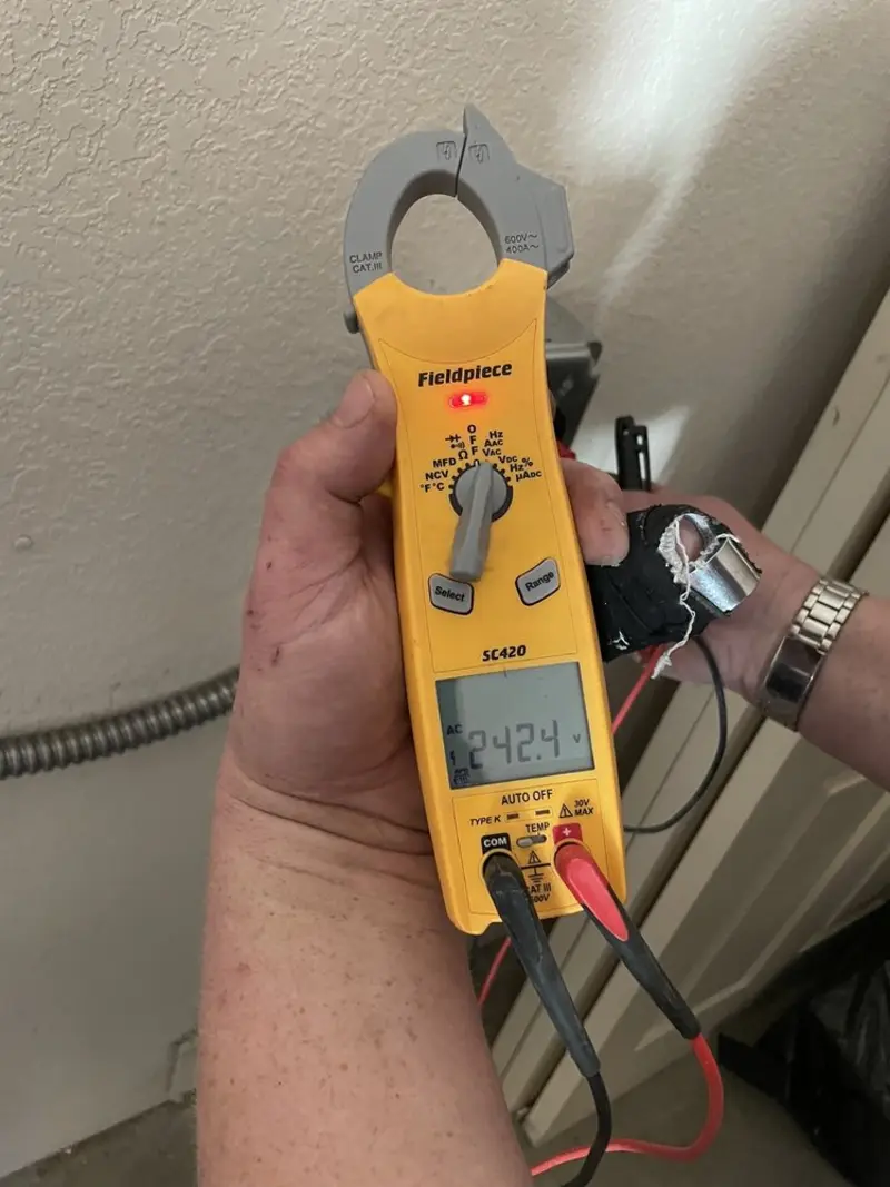Voltage testing with clamp meter during Whole House Surge Protector in Malverne